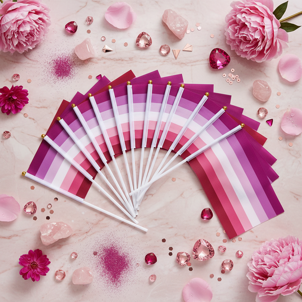 Fan of small lesbian pride flags with white handles on a pink floral backdrop