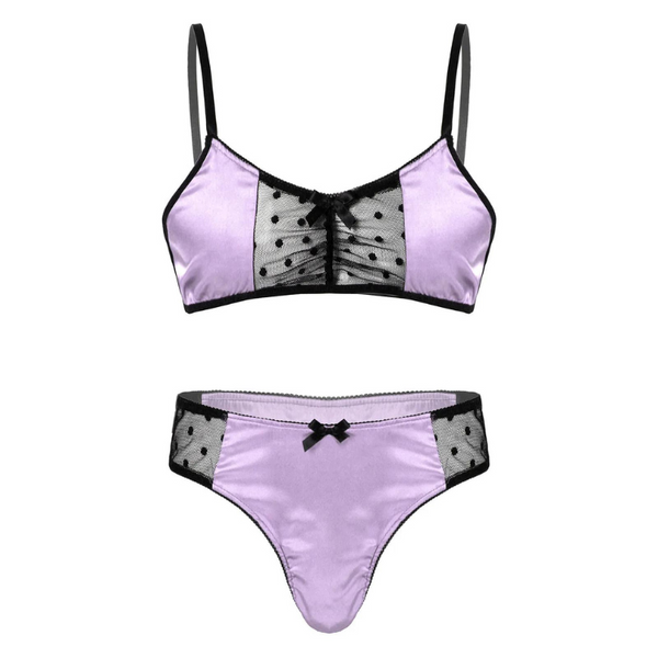 Front-facing flat lay of a lavender satin bra and matching thong with black mesh panels and bows