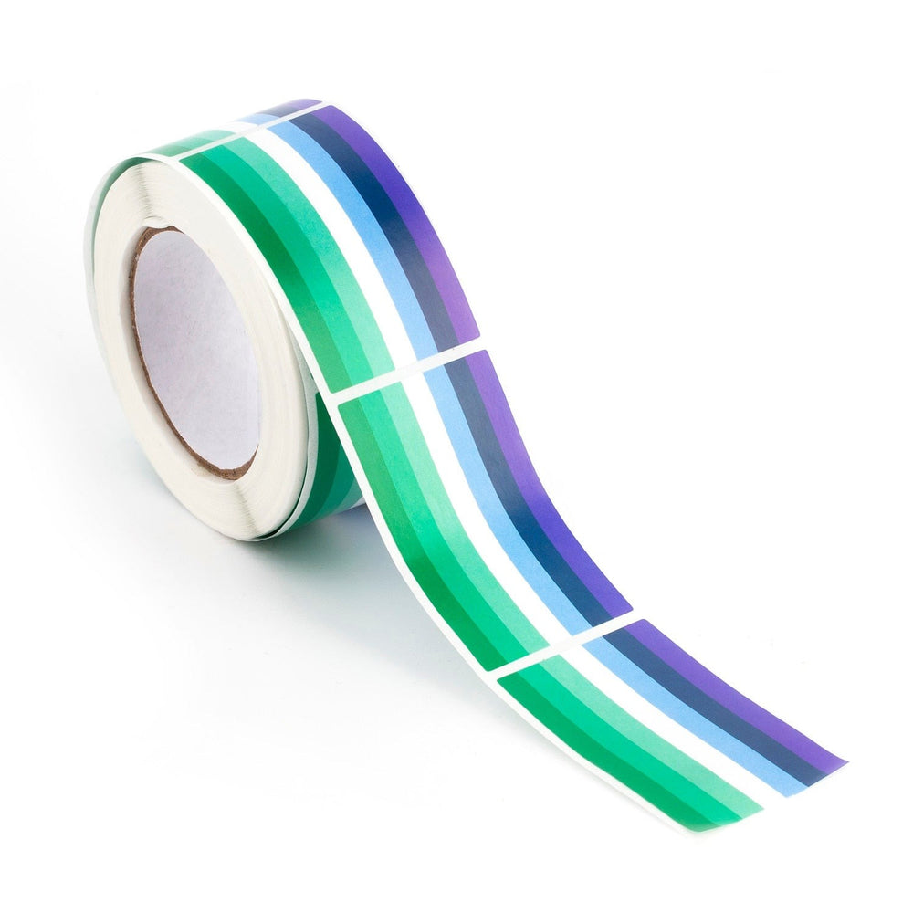 Roll of green, white, blue, and purple striped pride stickers with a strip unrolled