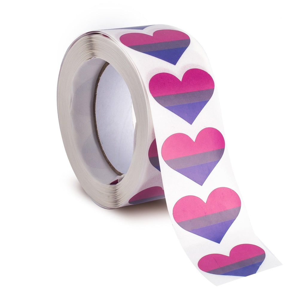 Roll of bisexual pride heart stickers, with the strip unspooling toward the viewer