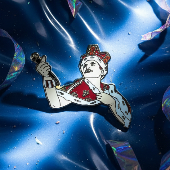 Freddie Mercury Enamel Pin featuring a robed, crowned figure with a microphone, embodying pride and fierce self-expression in red, white, and gold tones. Perfect for showcasing bold, joyful queer identity.