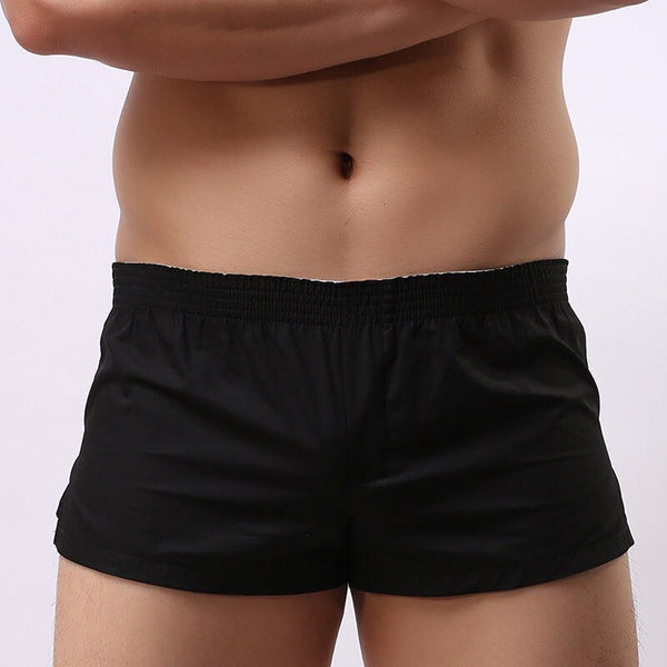 Close-up of a person wearing Rapido Quick Dry Shorts in black, showcasing a snug, flexible fit with an elastic waist, embodying queer pride and self-expression from Queer In The World: The Shop.