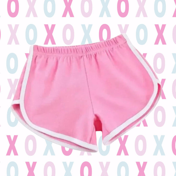 Women’s-style athletic shorts, Love Is In Motion Iconic Yoga Shorts, in solid pink with white trim, embody bold pride and self-expression. Perfect for celebrating individuality and embracing vibrant queer energy.