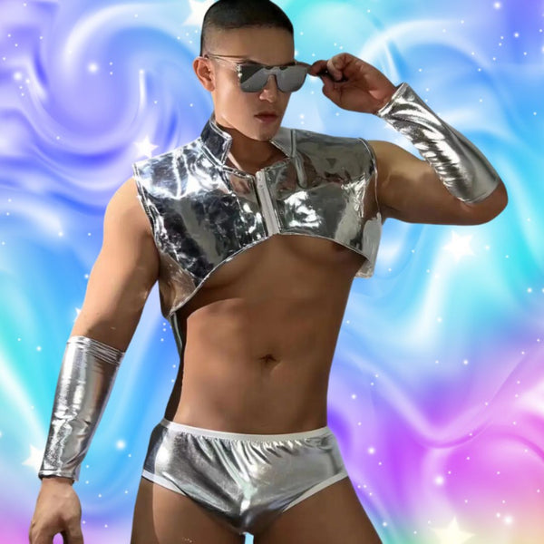 Queer Carnival King Men's Gogo Costume Set: A shirtless man in a metallic-silver vest, low-rise briefs, and forearm cuffs, exuding prideful confidence with reflective aviator sunglasses against a dreamy backdrop.