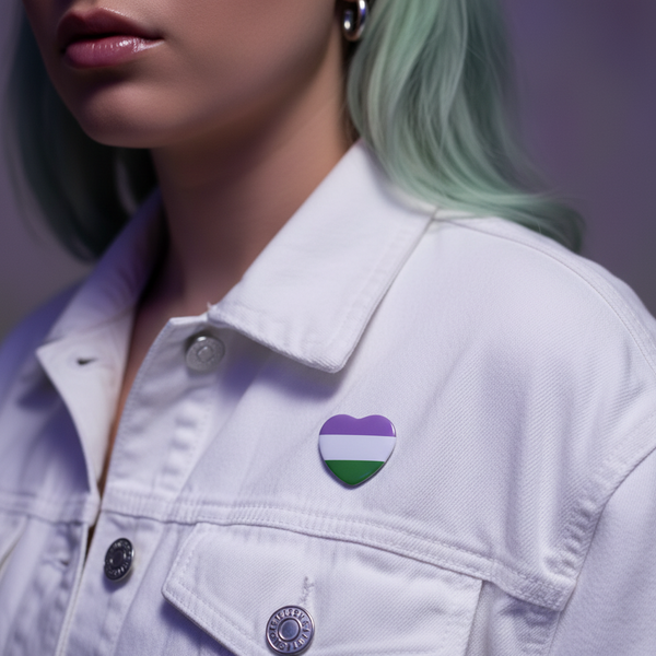 Close-up of a person wearing a white denim jacket with the Genderqueer Pride Heart Badge on the lapel, featuring lavender, white, and green stripes. The badge symbolizes genderqueer pride and self-expression.