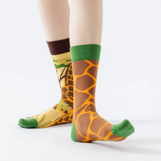 Asymmetrical giraffe socks with mismatched cartoon giraffe patterns