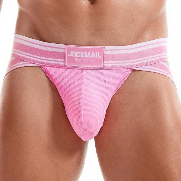 Male model in Jockmail Fiesta Jockstrap with JOCKMAIL waistband, showcasing a supportive, contoured fit and double-strap design, embodying bold, sexy, and confident queer energy.