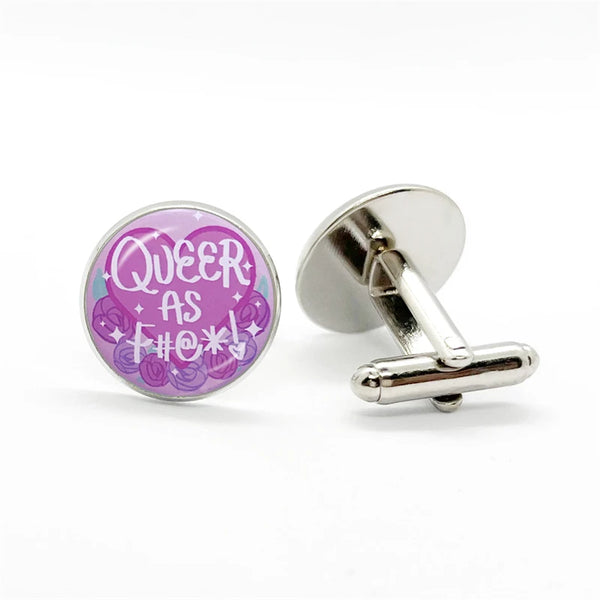 Queer AF Pride Cufflinks featuring a circular purple enamel with “QUEER AS F#@*!” text and rose motif, showcasing LGBTQ pride with a sleek design for bold, empowering self-expression.