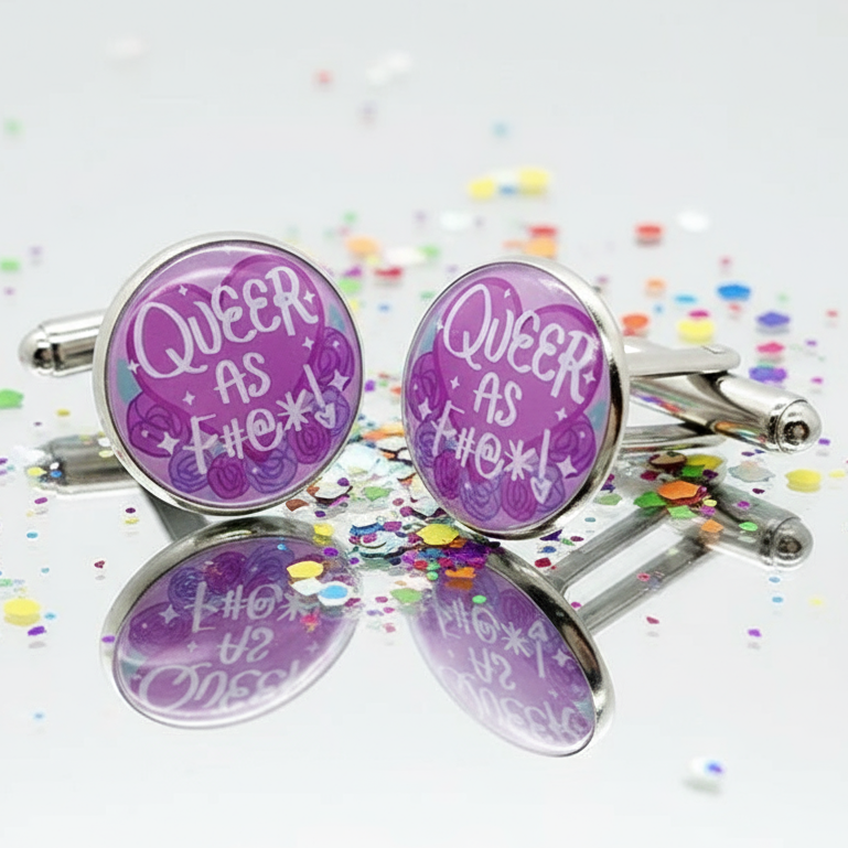 Queer AF Pride Cufflinks with purple rose motifs and QUEER AS F#@*! slogan on mirrored surface, embodying vibrant LGBTQ pride and self-expression.