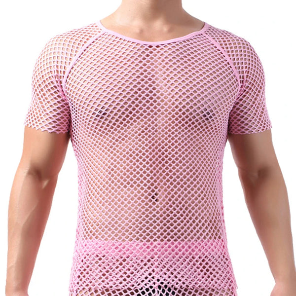 Person wearing the Coloured Mesh T-Shirt, a pink, short-sleeved fishnet top showcasing bare skin and pink underwear, embodying bold, queer self-expression and unapologetic visibility.