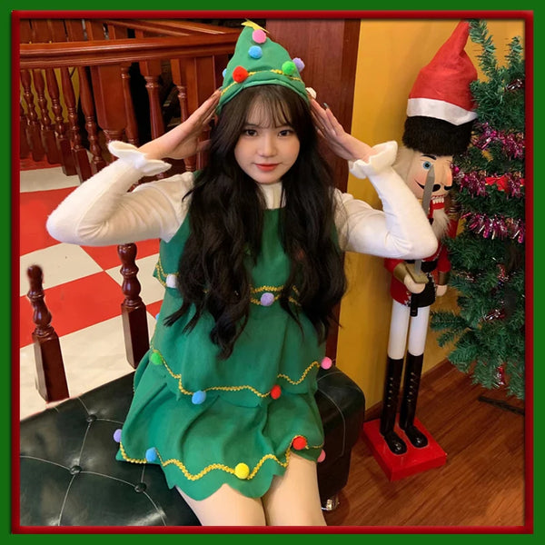 Model wearing a green Christmas tree dress and matching decorated tree hat