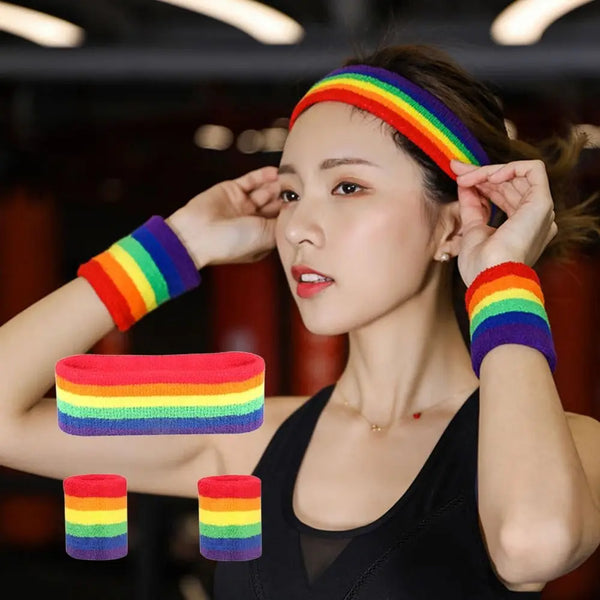Model wearing a rainbow-striped headband and wristbands, with extra bands shown below