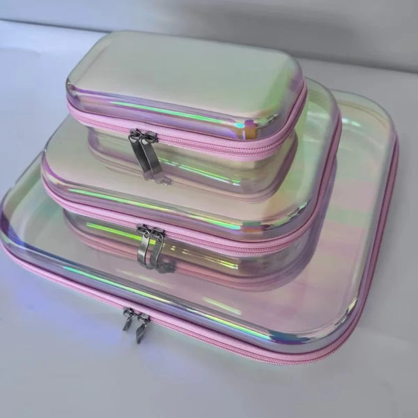Stack of three iridescent rectangular storage boxes with pink zippers
