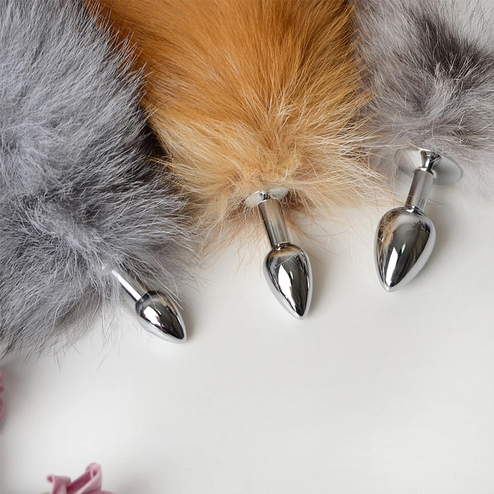Three fluffy fox-tail butt plugs with polished silver teardrop-shaped bases