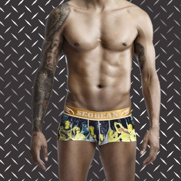 SEOBEAN Luxe Print Silk Low-Waist Boxers on a tattooed male model, showcasing a gold waistband and vibrant graphic design. Perfect for proud and bold self-expression, embodying queer empowerment and modern elegance.