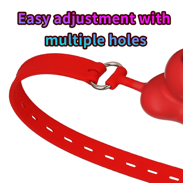 Close-up of a red ball gag strap with multiple adjustment holes and metal rings