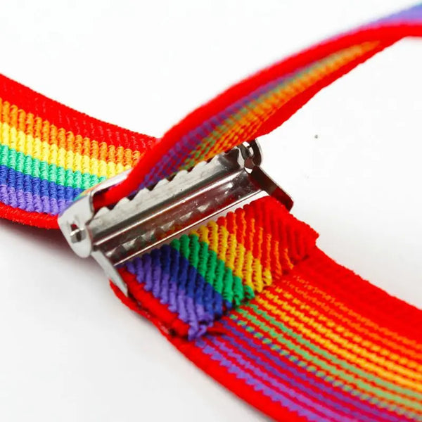 Close-up of rainbow-striped suspender straps joined by a shiny metal adjuster