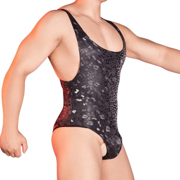 Person wearing the Second Skin Fantasy Men’s Bodysuit, a black, shiny, animal-print one-piece with a low cut, accentuating contours and embodying bold, queer self-expression and empowerment.
