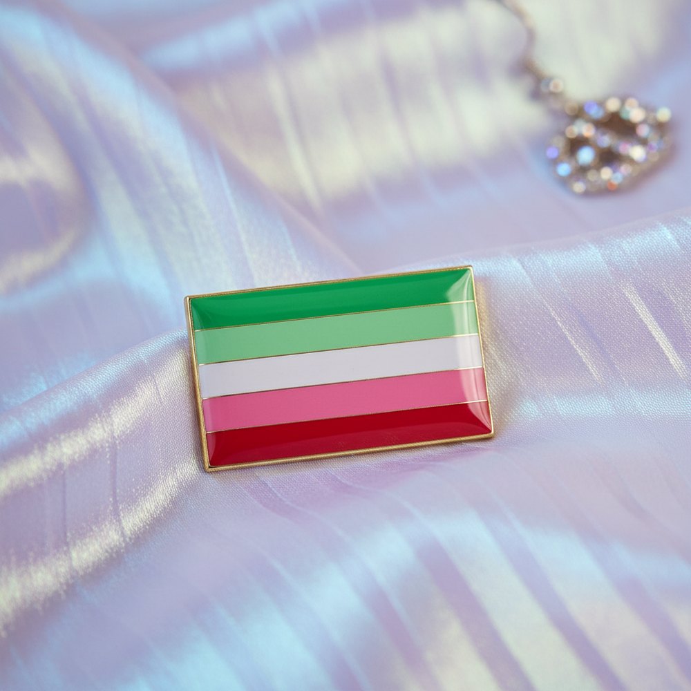 Rectangular green, white, pink, and red enamel pin on iridescent satin