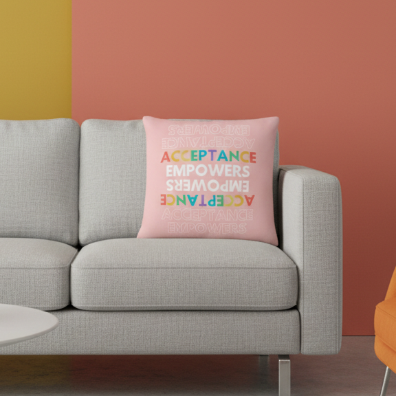 The Acceptance Empowers Pillow, bold colorful lettering on a light gray cushion