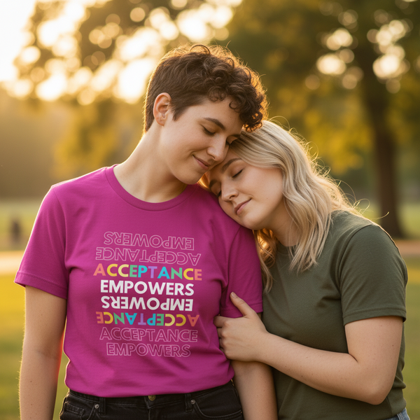 Acceptance Empowers T-Shirt in bright rainbow letters worn by a smiling person