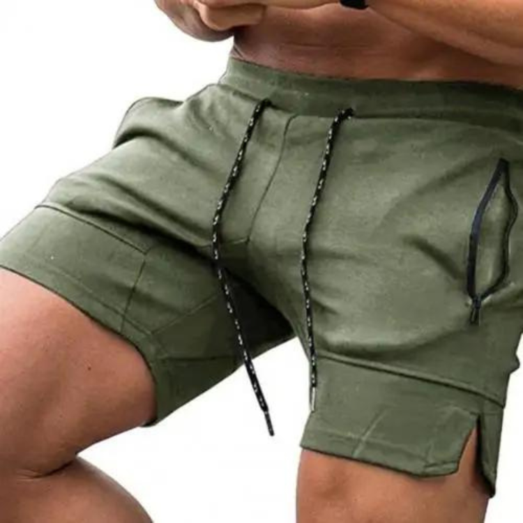 Close-up of a model wearing olive green sports shorts with drawstrings and side pockets