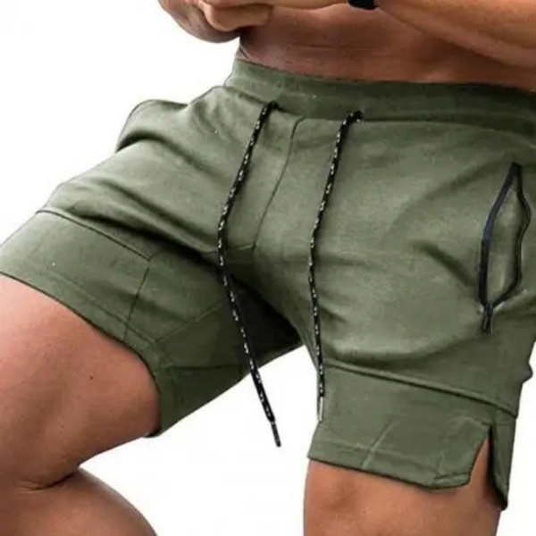 Close-up of a model wearing olive green sports shorts with drawstrings and side pockets
