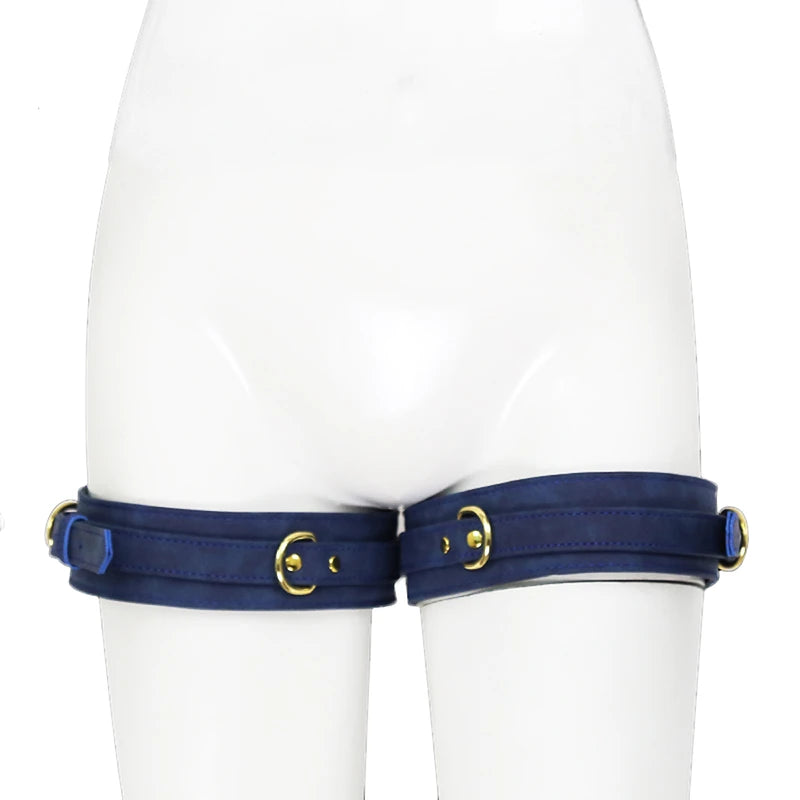 Front view of a white mannequin wearing navy thigh cuffs with gold-tone buckles and rings