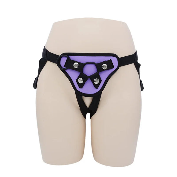 Front view of a purple-and-black adjustable strap-on harness on a mannequin lower torso