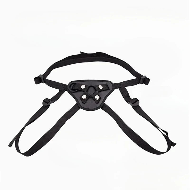 Black adjustable strap-on harness with a padded triangular front panel and four metal studs