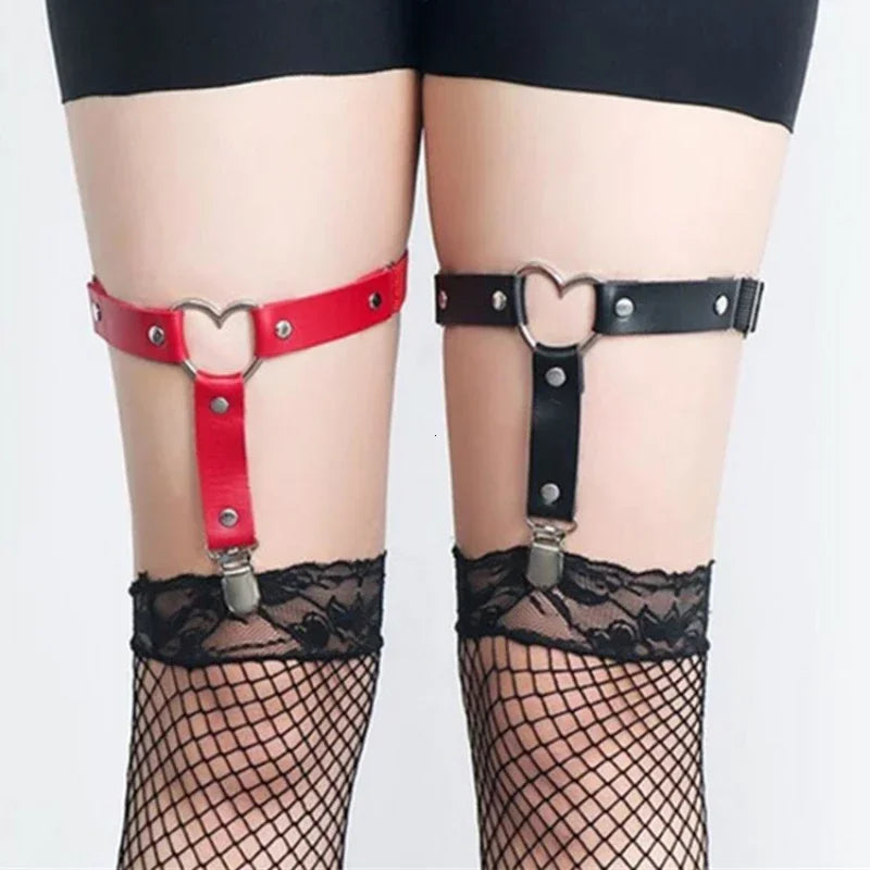 Close-up of red and black heart-ring thigh garters clipped to lace-top fishnet stockings