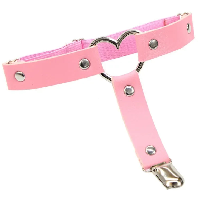 Close-up of pink thigh garters with silver rings, studs, and an attached metal clip