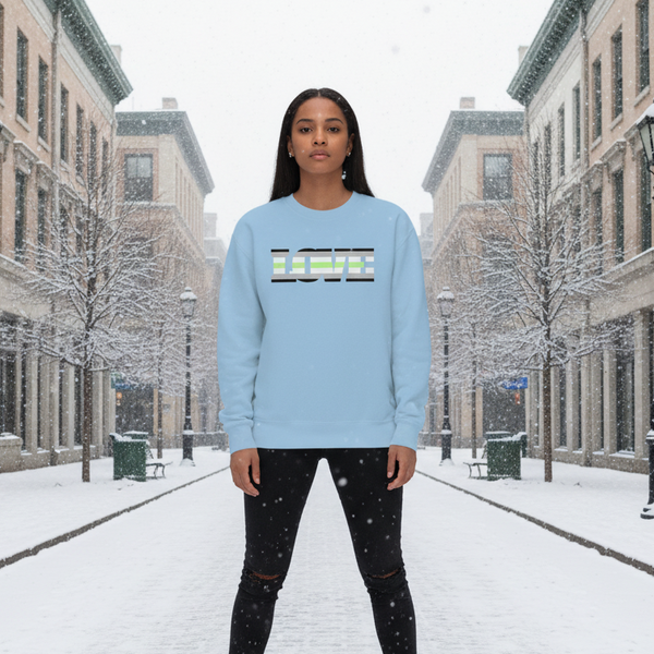 Model wearing a light blue sweatshirt with striped LOVE lettering in a snowy street