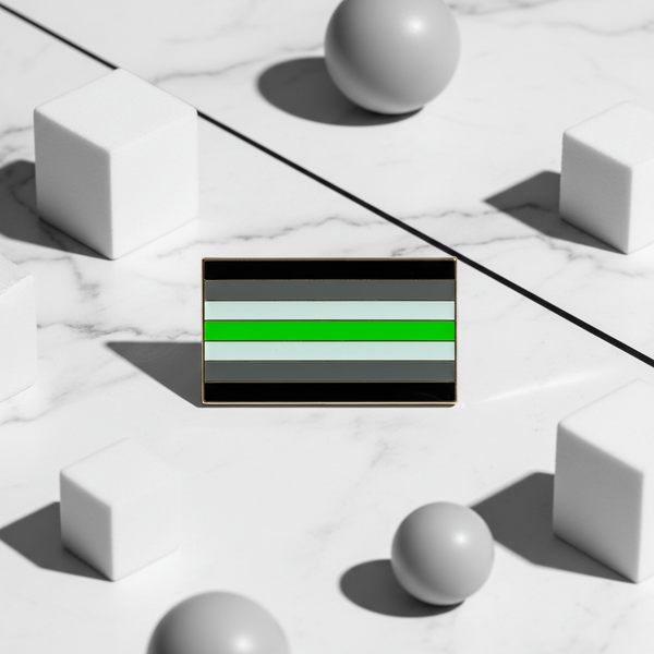 Rectangular agender pride flag enamel pin with black, gray, white, and green stripes on marble