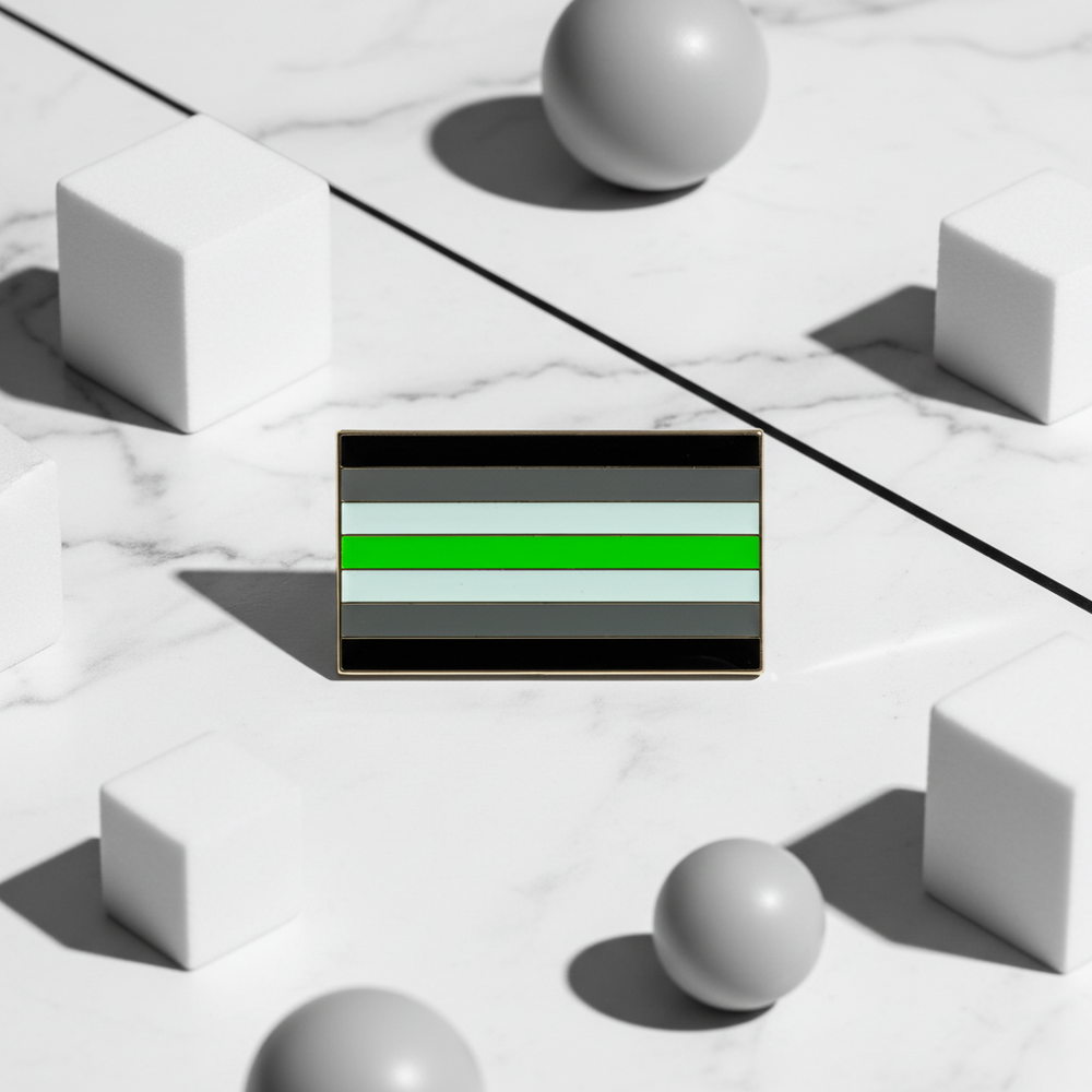 Rectangular agender pride flag enamel pin with black, gray, white, and green stripes on marble