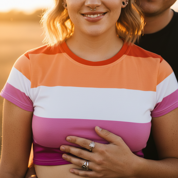 Close-up of a smiling person in a pink, white, and orange striped crop T-shirt