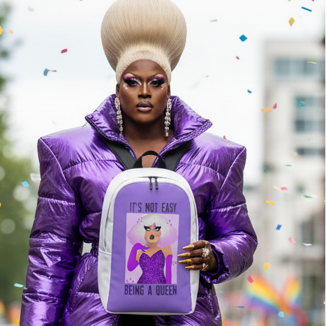 It's Not Easy Being A Queen Minimalist Backpack," with a glamorous queen graphic, held by a person in a shiny purple puffer and lavender wig.