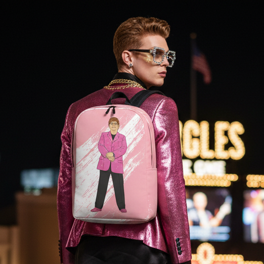 Elton John Minimalist Backpack with a pink-suited figure, worn by a queer person with short red hair and rhinestone shades at night.