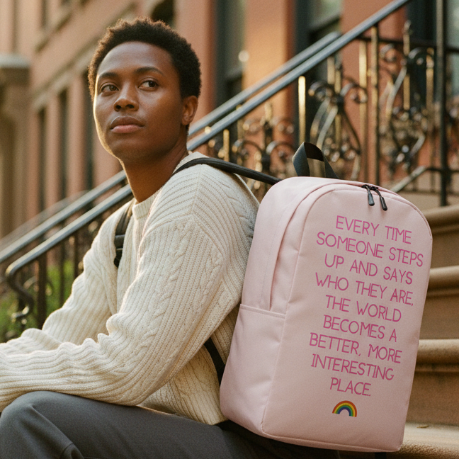 Minimalist backpack with the quote, “Every time someone steps up and says who they are, the world becomes a better place,” plus a rainbow.