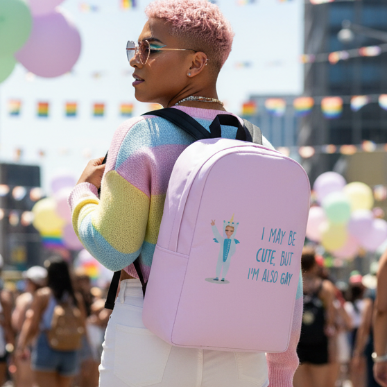 Cute But Gay Minimalist Backpack with “I may be cute, but I’m also gay” slogan, pastel stripes, rainbow flags, queer pride vibes.