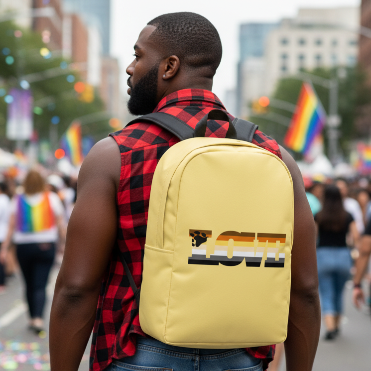 Gay Bear Love Minimalist Backpack with "LOVE" in rainbow LGBTQ+ colors, carried by a bearded guy at a pride parade, rainbow flags behind.
