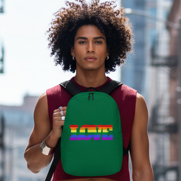 Gay Love Minimalist Backpack with bold "LOVE" in rainbow colors, worn by a curly-haired person in maroon, serving queer city vibes.