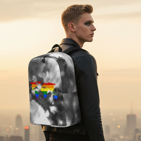Gay Map Minimalist Backpack with a bold rainbow map print, worn by a short blond-haired person in dark eye makeup and black leather jacket at sunset city's glow.