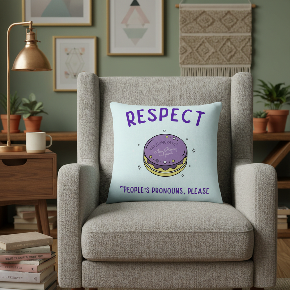 Gray armchair with "RESPECT" Pride pillow—macaron illustration, "Peoples pronouns, please"—in a warm, art-filled living room.