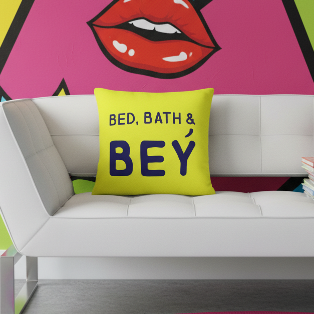 Modern white sofa with plush cushion, Bed, Bath & Bey Pillow in bold blue text on yellow, queer flair; red lips mural behind.