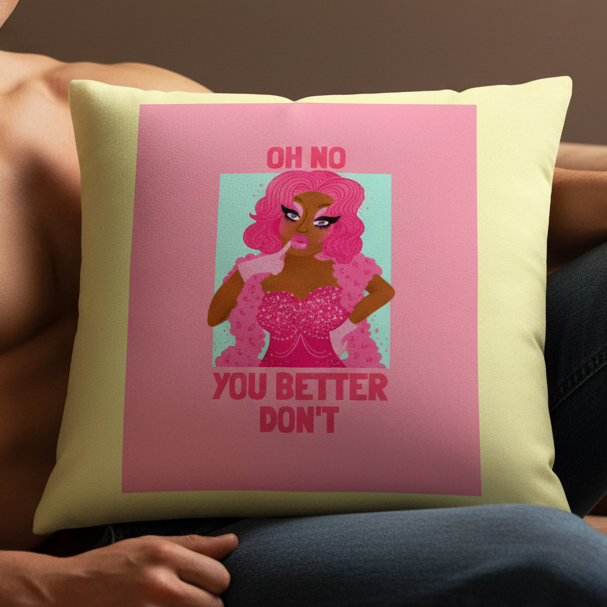 Light yellow pillow with "OH NO YOU BETTER DONT" in bold pink, featuring a drag queen with pink hair, boa, and sparkly dress.
