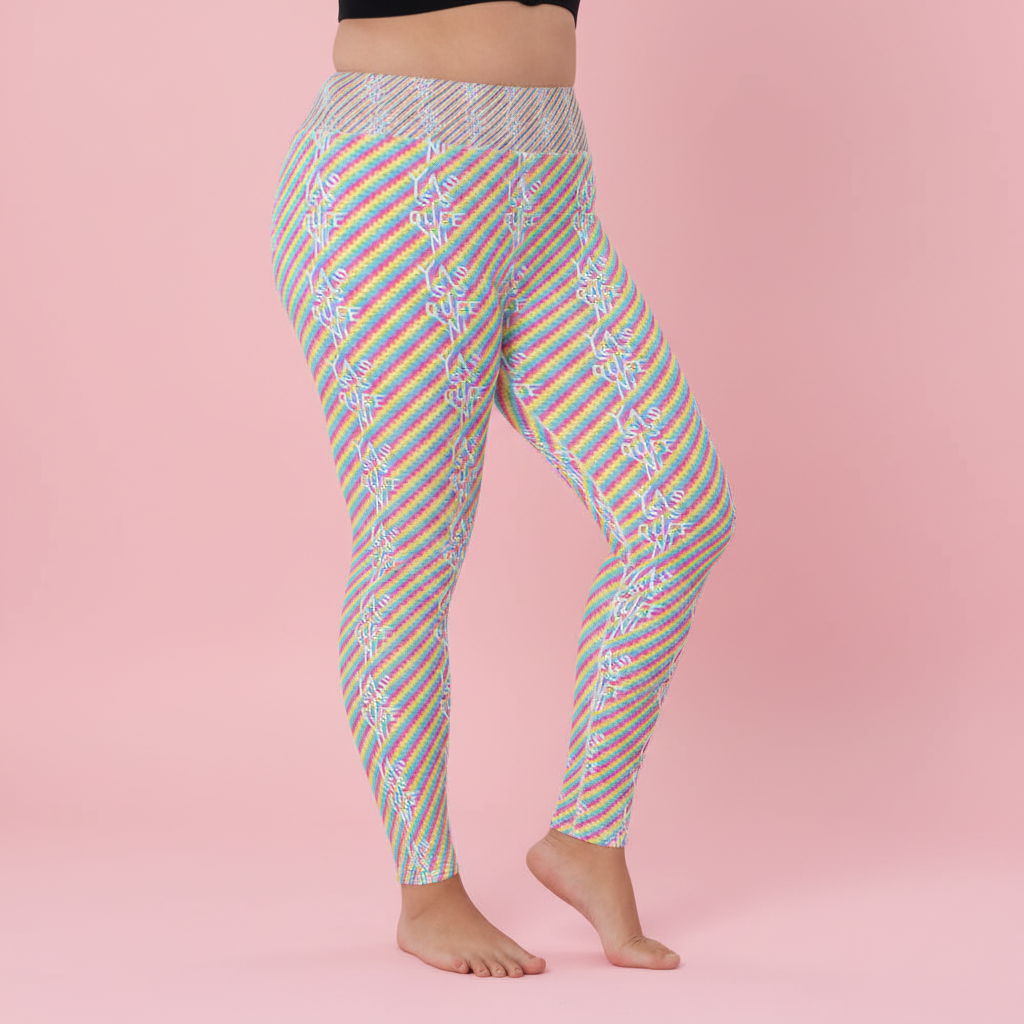 Yasss Queen Yoga Leggings on a lower torso, high-waisted and snug with pastel diagonal stripes, white geometric print, pink backdrop.