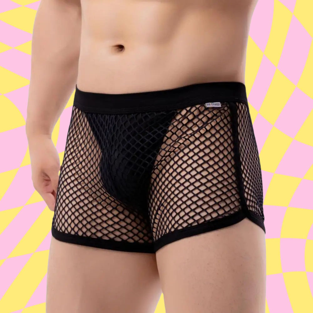 Front-facing cropped model wearing black fishnet boxer briefs with a solid pouch and waistband