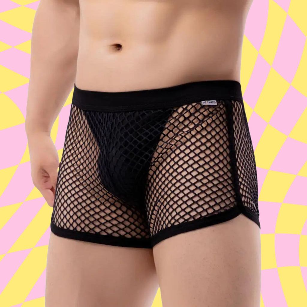 Front-facing cropped model wearing black fishnet boxer briefs with a solid pouch and waistband