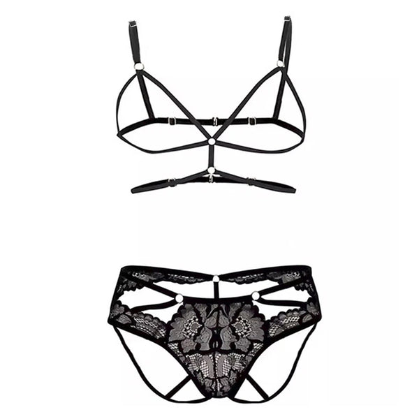 Flat-lay black strappy bondage harness with matching floral lace underwear
